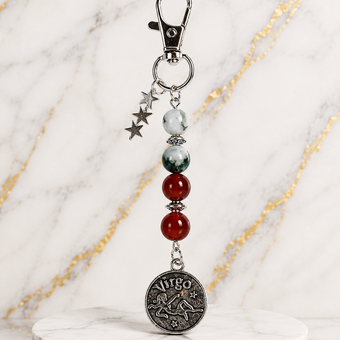 Keychain with beads and a zodiac charm on a marble stand