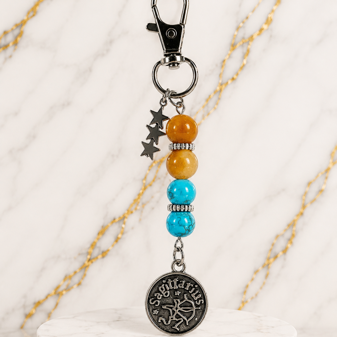 Keychain with beads and a decorative charm on a marble base