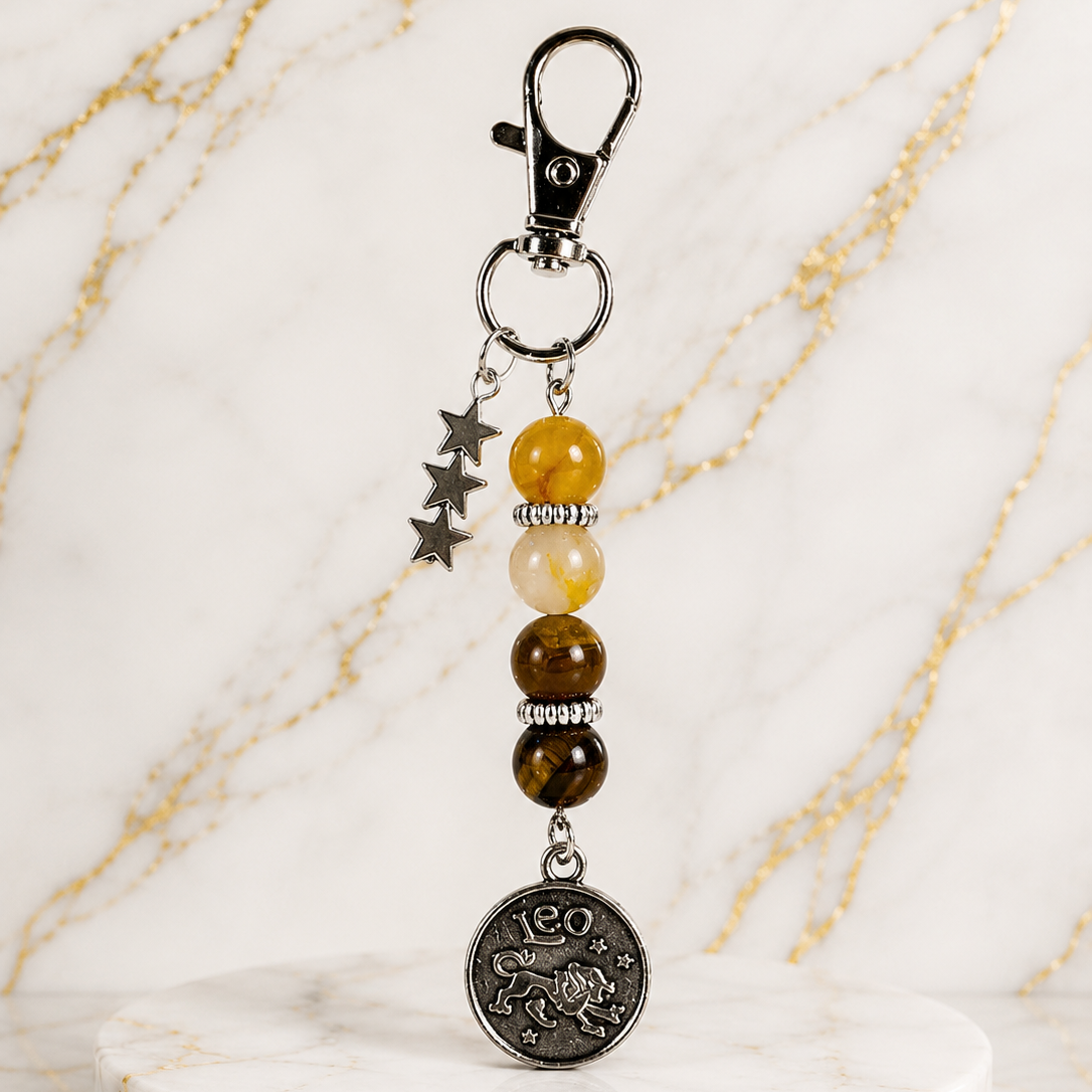 Keychain with beads and a coin charm on a marble surface