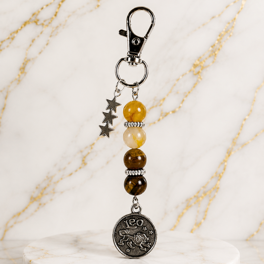 Keychain with beads and a coin charm on a marble surface