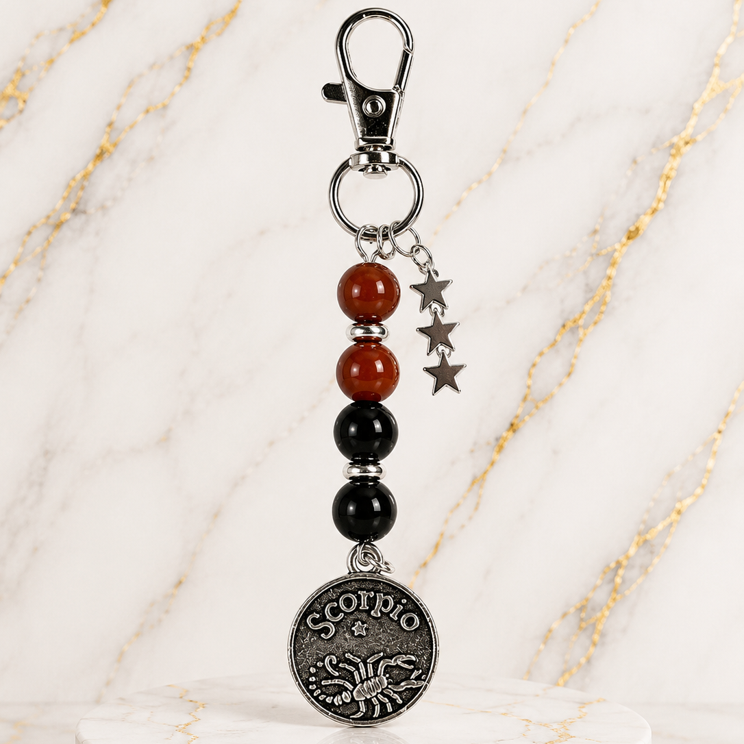 Keychain with beads and Scorpio pendant on a marble surface