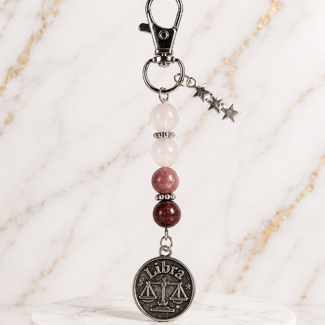 Keychain with Libra coin charm on a marble base