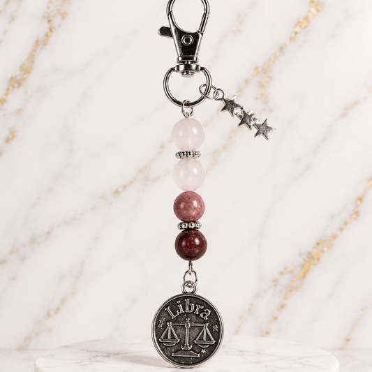 Keychain with Libra coin charm on a marble base